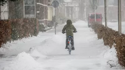 person biking down a snowy road