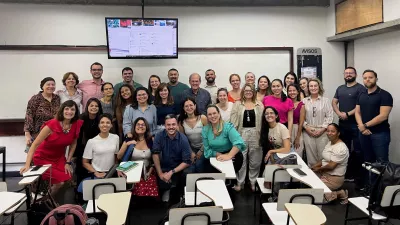 large group of collaborators gathers in a classroom