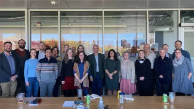 Nordic Collaborators taking a group photo in a conference room.